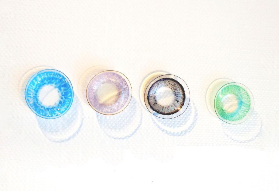 Colored contact lenses on white background, closeup