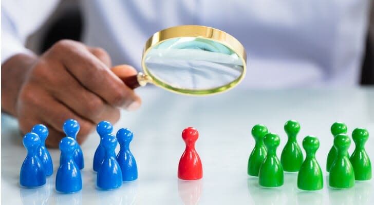 Looking through a magnifying glass at a chess piece