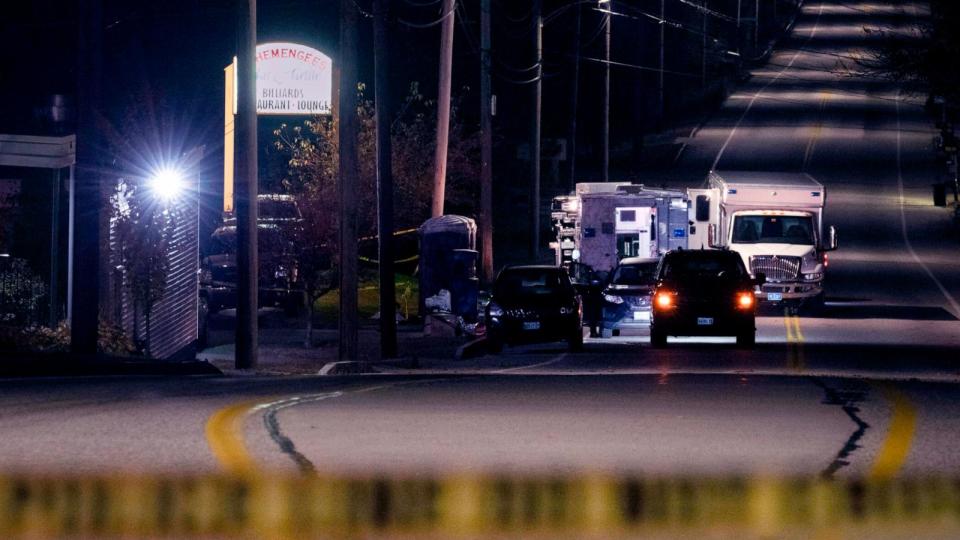 PHOTO: Police tape cordons off the road to Schemengees Bar and Grille as law enforcement officers maintain their presence in the aftermath of a mass shooting by Army reservist Robert Card in Lewiston, Maine, Oct. 27, 2023. (Matt Rourke/AP, FILE)