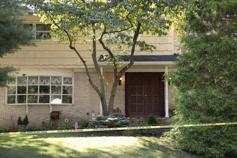 Crime scene tape surrounds the home of U.S. District Judge Esther Salas, Monday, July 20, 2020, in North Brunswick, N.J. A gunman posing as a delivery person shot and killed Salas' 20-year-old son and wounded her husband Sunday evening at their New Jersey home before fleeing, according to judiciary officials. (AP Photo/Mark Lennihan)