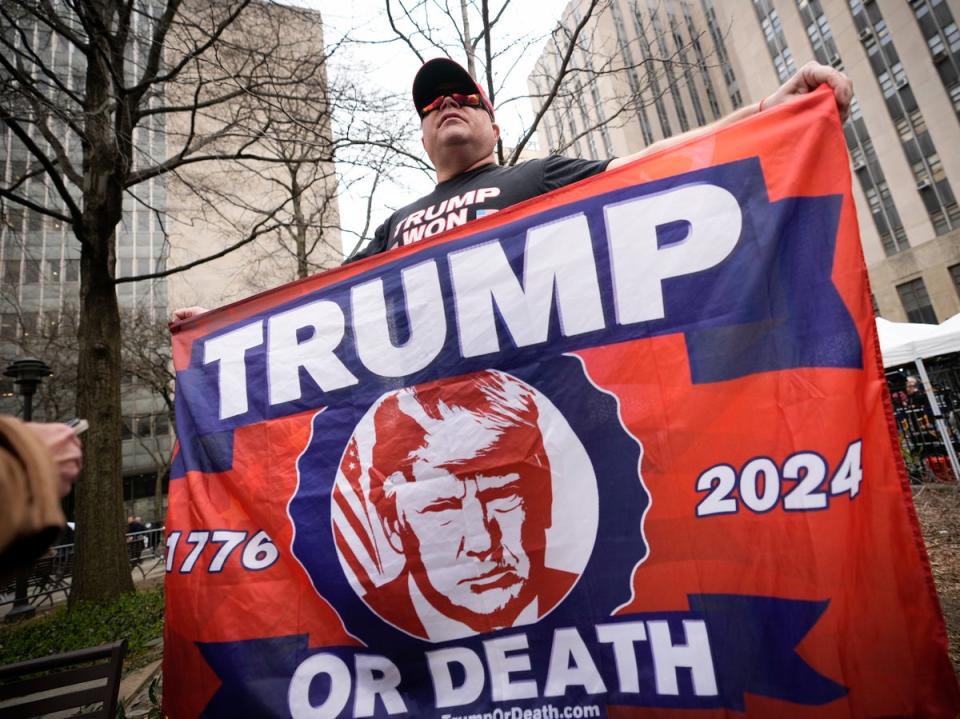 A Trump supporter brandishing a ‘Trump or Death’ banner in New York on Tuesday (Drew Angerer/Getty)