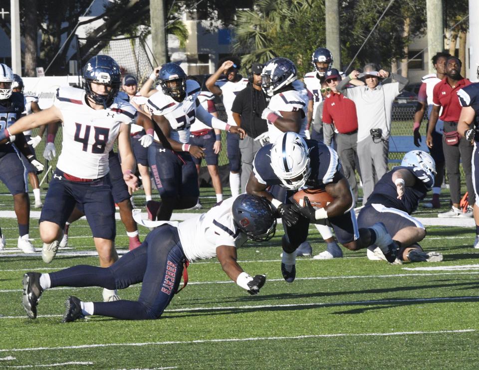 Keiser's Marques Burgess bounces off a tackle after bursting into the secondary on a second-quarter run against St. Thomas University. He totaled 171 yards and three touchdowns in the contest.