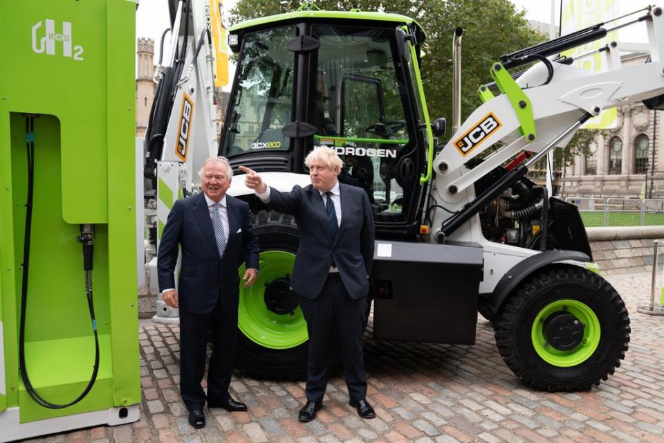 Prime Minister Boris Johnson and JCB chairman Lord Bamford at the unveiling of a hydrogen-powered JCB Loadall telescopic handler (Stefan Rousseau/PA) (PA Wire)