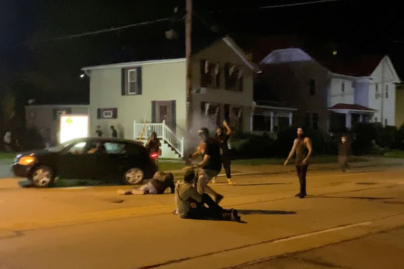 A man is being shot in his arm during a protest following the police shooting of Jacob Blake, a Black man, in Kenosha