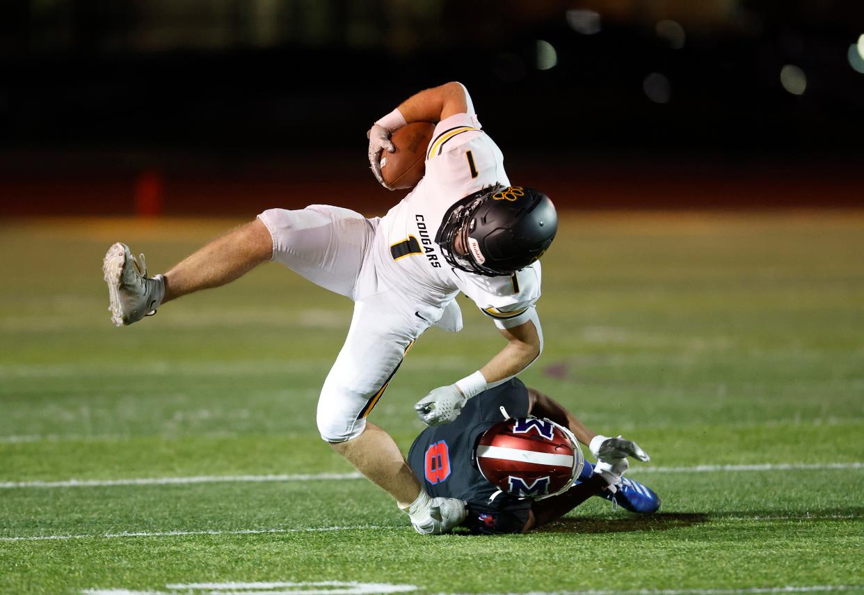 Honeoye Falls-Lima’s Ben Cook is tackled by Monroe’s Robert Arnold.