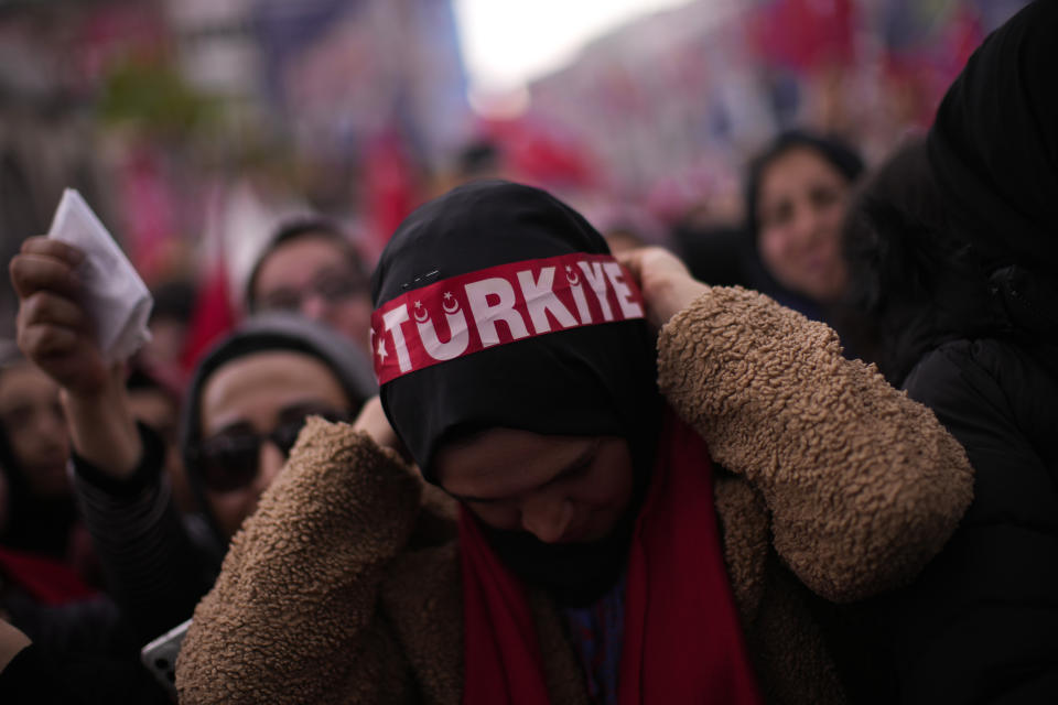 A woman puts on a headband that reads: "Turkey" during an election rally campaign of President and People's Alliance's presidential candidate Recep Tayyip Erdogan in Istanbul, Turkey, Friday, April 21, 2023. Presidential elections in Turkey are scheduled to take place on May 14. (AP Photo/Francisco Seco)