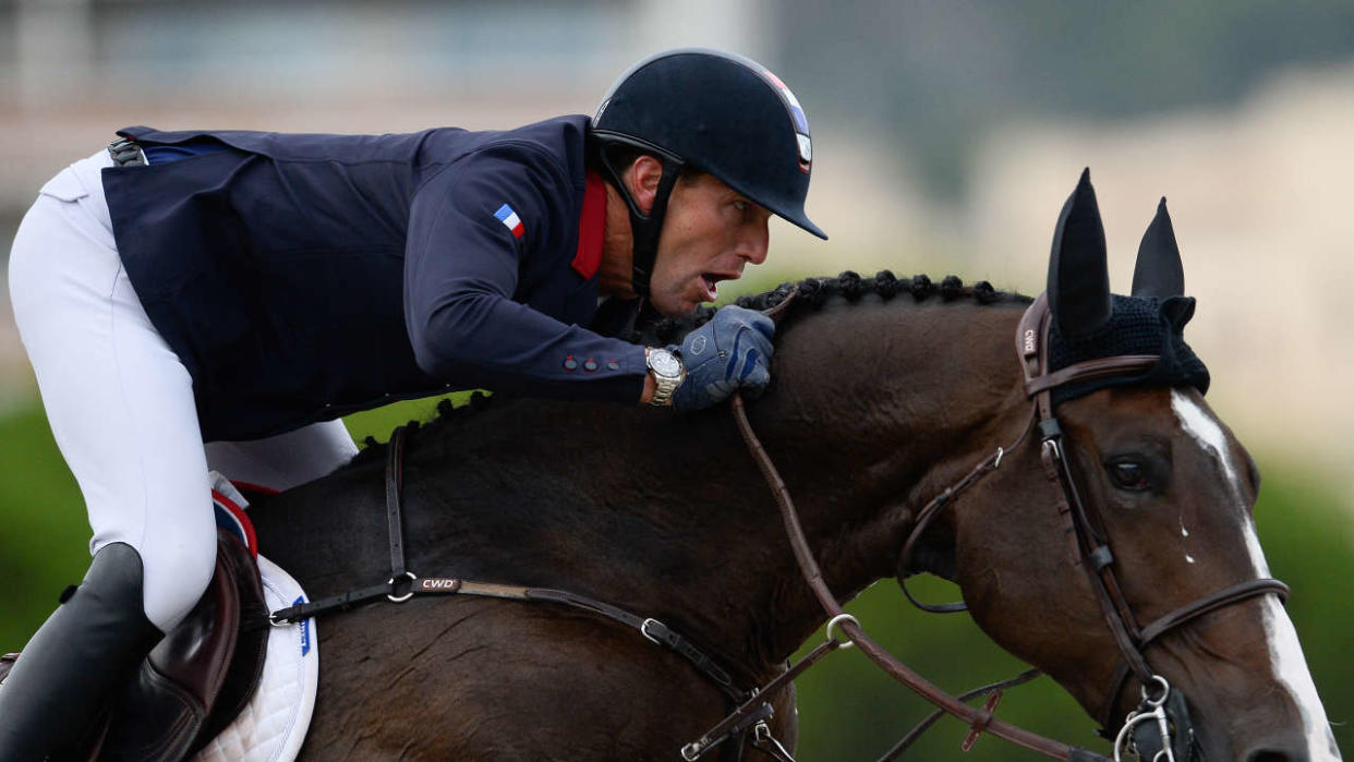 France's horseman Kevin Staut steers his horse Urhelia Lutterbach as they compete in the Longines FEI Jumping Nations Cup Final at the Olympic arena of the Real Club de Polo of Barcelona on October 6, 2019. (Photo by PAU BARRENA / AFP)