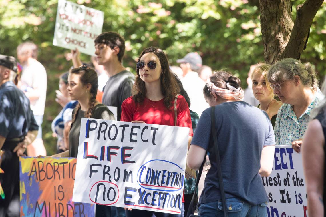 People in support and against banning abortion wait to enter the Solomon Blatt Building at the South Carolina State House before a hearing on Thursday, July 7, 2022.