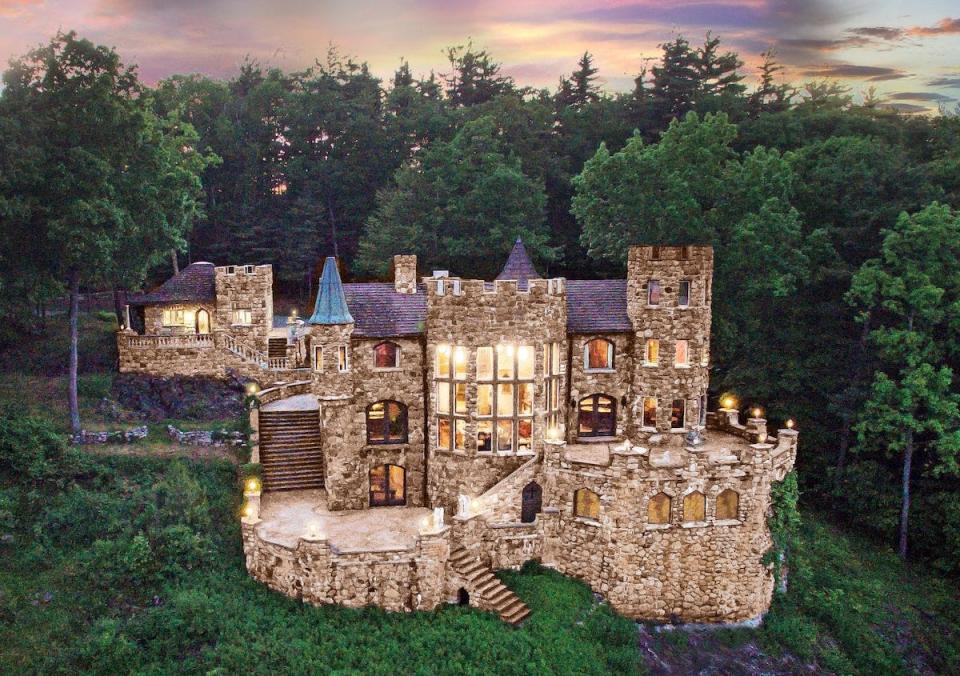 Highlands Castle, surrounded by forest, at dusk.