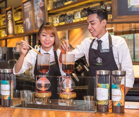 Two Starbucks employees in a Southeast Asia store.