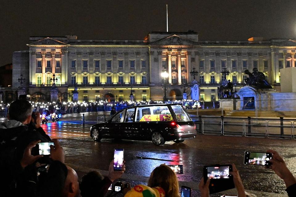 The coffin of Queen Elizabeth II arrives in the Royal Hearse at Buckingham Palace in London on September 13, 2022, where it will rest in the Palace's Bow Room overnight.