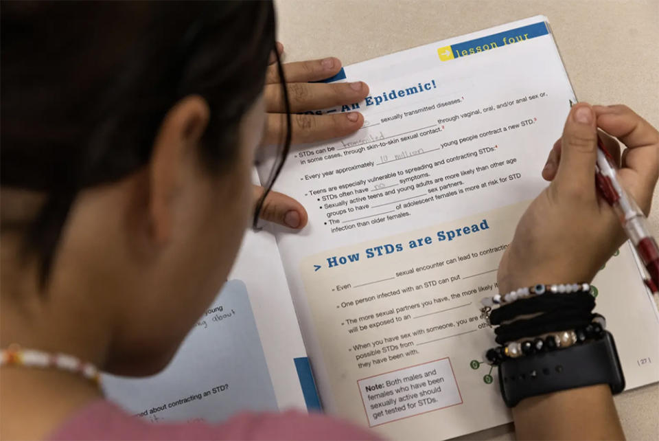 Tenaha High School students fill in the blanks of their “Choosing the Best Life” workbooks on Nov. 11, 2022, as an instructor from a nonprofit that provides abstinence-based sex education reads out information on STDs. Tenaha ISD is in Shelby County in Deep East Texas. (Shelby Tauber / The Texas Tribune)