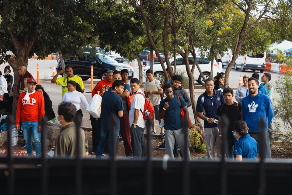 People waiting outside a migrant resource center 