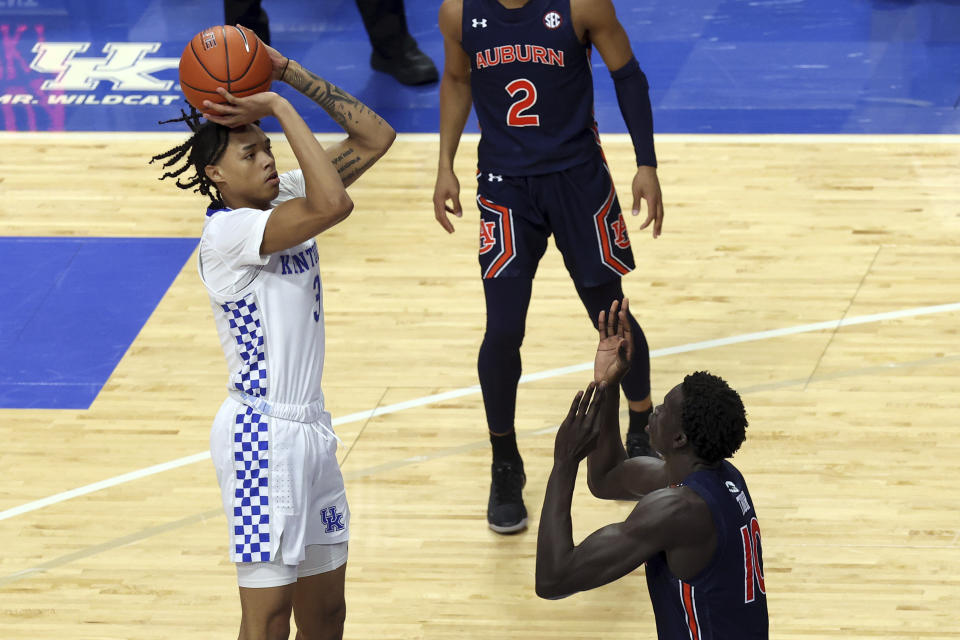 Kentucky's B.J. Boston, left, shoots over Auburn's JT Thor during the second half of an NCAA college basketball game in Lexington, Ky., Saturday, Feb. 13, 2021. (AP Photo/James Crisp)