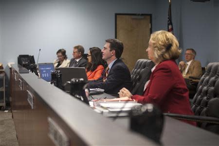 The Arizona Corporations Commission listens to residents and solar employees in Phoenix November 13, 2013. REUTERS/Samantha Sais