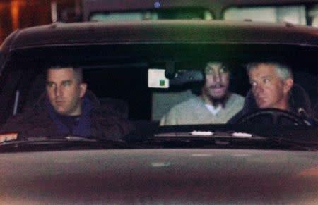 Convicted "shoebomber" Richard Reid (C, rear) leaves U.S. Federal Court in Boston, Massachusetts, January 30, 2003. REUTERS/Brian Snyder