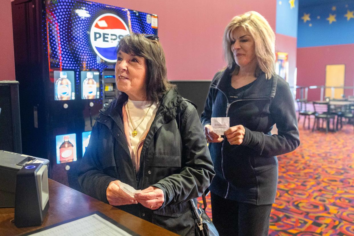 Aurora residents Dolly Spinelli, left, and Leslie Wazbinski get their tickets ready Saturday, April 13, 2024, on their way to see "Cabrini" at the newly opened Atlas Cinemas Barrington 10 in the Barrington Town Center shopping center.