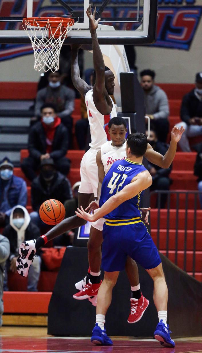 Delaware forward Dylan Painter flips a pass behind his back as Delaware State&#39;s Christopher Sodom (top) and Myles Carter defend in the first half of the first half of Delaware&#39;s 59-48 win at Memorial Hall in Dover, Thursday, Dec. 2, 2021.