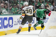 Vegas Golden Knights right wing Anthony Mantha (39) and Dallas Stars defenseman Chris Tanev (3) compete for possession of the puck during the second period in Game 2 of an NHL hockey Stanley Cup first-round playoff series in Dallas, Wednesday, April 24, 2024. (AP Photo/Tony Gutierrez)