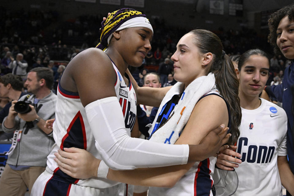 UConn's Aaliyah Edwards, left, and Nika Muhl embrace at the end of a second-round college basketball game in the NCAA Tournament against Syracuse, Monday, March 25, 2024, in Storrs, Conn. (AP Photo/Jessica Hill)