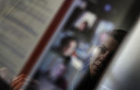 Lina Maria Fajardo of Colombia, student in psychiatry of old people is reflected in the screen of her computer as she attends a remote course in her student housing in Ivry sur Seine, outside Paris, Thursday, Feb. 11, 2021. Nearly a quarter of French young people can’t find work, and many university students now rely on food aid. A hotline devoted to students has seen a surge in calls, and young people have streamed into psychiatric wards. (AP Photo/Christophe Ena)