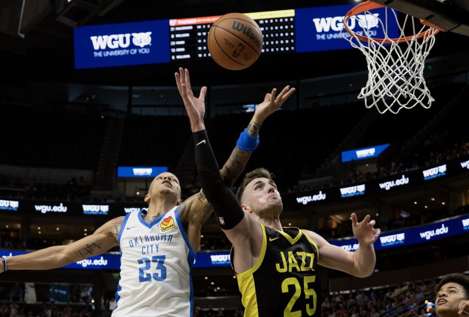 Oklahoma City’s Tre Mann and Utah Jazz’ Micah Potter battle for the ball as they play in Summer League action at the Delta Center in Salt Lake City on Monday, July 3, 2023. Oklahoma won 95-85. | Scott G Winterton, Deseret News