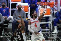 New York Knicks guard Derrick Rose (4) scores past Los Angeles Clippers forward Marcus Morris Sr. (8) during the first half of an NBA basketball game Sunday, May 9, 2021, in Los Angeles. (AP Photo/Marcio Jose Sanchez)