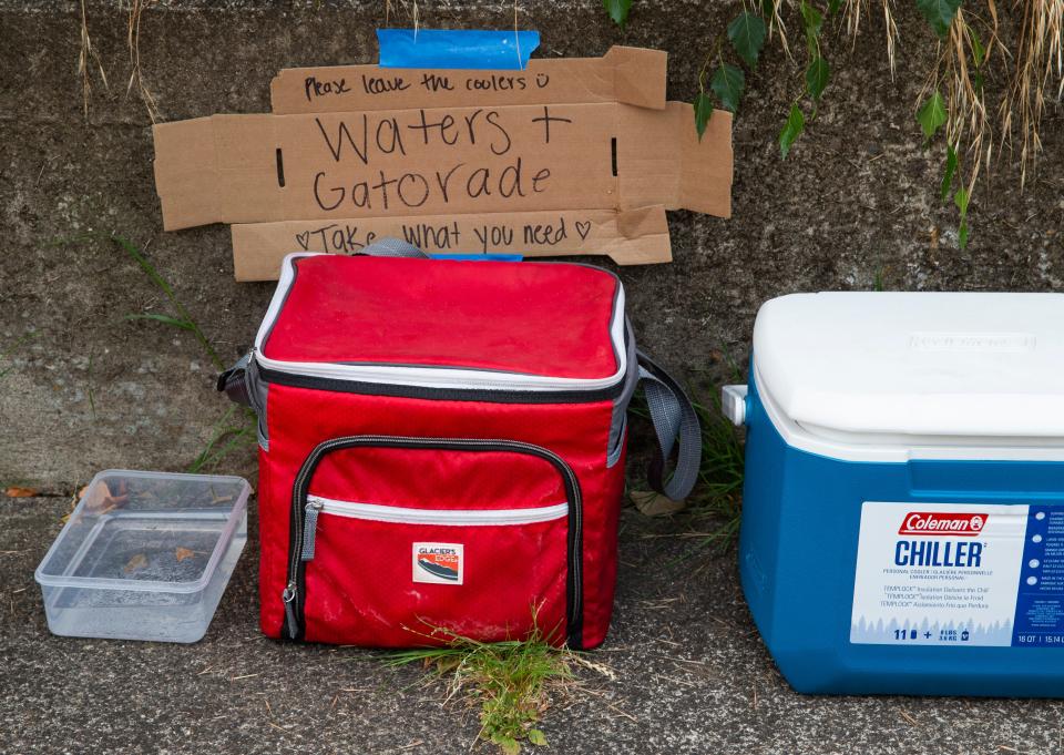 A kindly neighbor in Eugene leaves a selection of drinks Tuesday for people and pets on the sidewalk near their home as temperatures soar in the Willamette Valley.