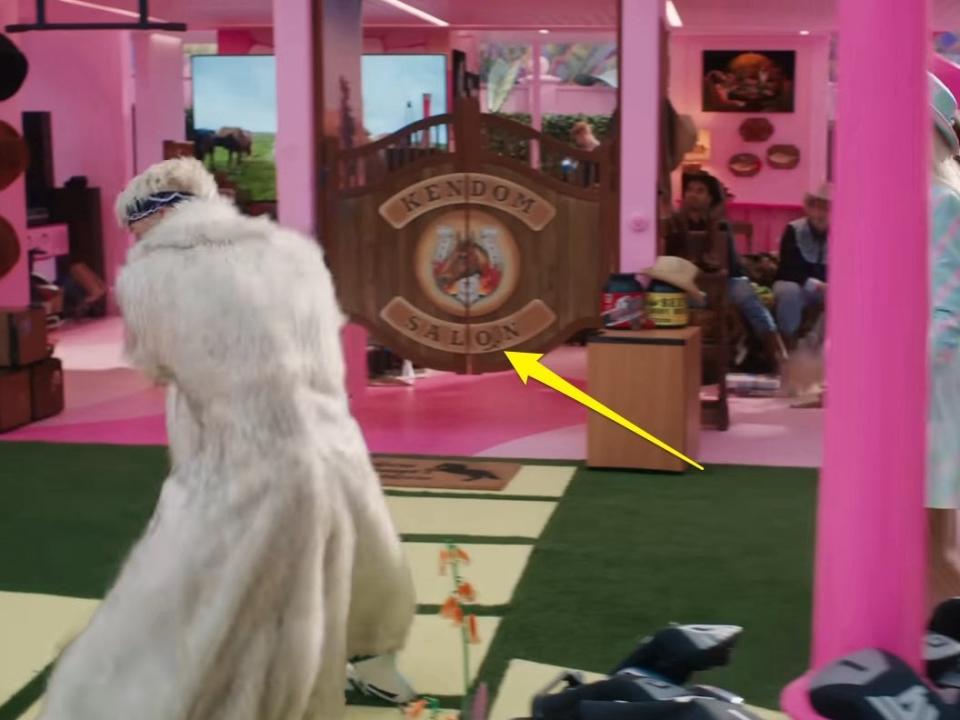 A yellow arrow pointing to a saloon sign in "Barbie."