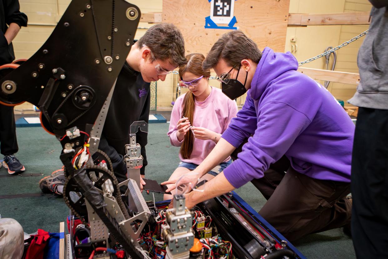 Callaway Macovis, right, works with Noah Adams, left and Kylie Perez on Marvin the robot during a meeting of the South Eugene Robotics Team Tuesday, March 19, 2024, at South Eugene High School.