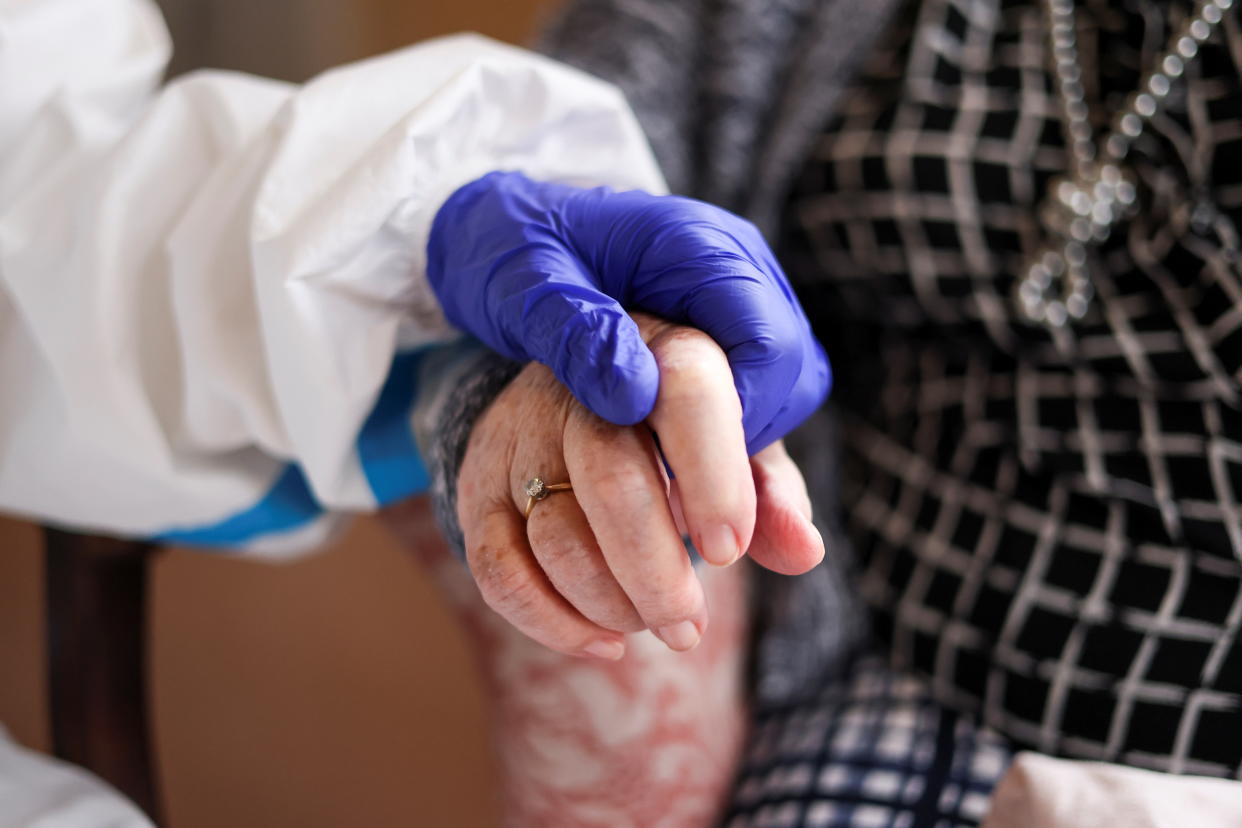 Nicky Clough visits her mother Pam Harrison in her bedroom at Alexander House Care Home for the first time since the coronavirus disease (COVID-19) lockdown restrictions begin to ease, in London, Britain March 8, 2021. REUTERS/Hannah Mckay