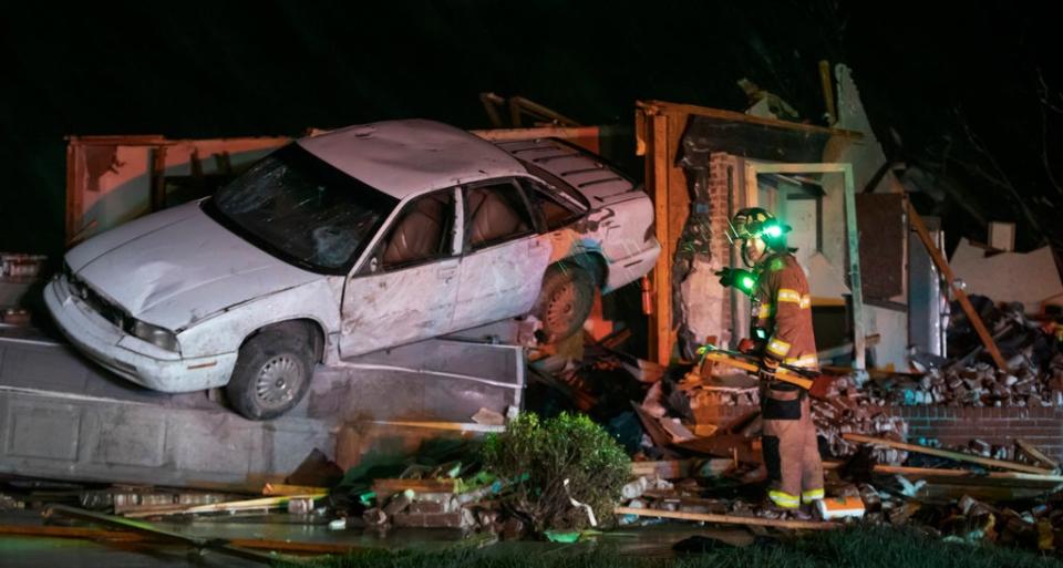 Firefighters survey the aftermath of the tornado in Kansas on Friday night (AP)