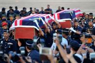 Malaysian police carry the coffins of two dead officers killed in an ambush in Semporna, at the Subang Royal Malaysian Air Force base in Kuala Lumpur on March 4, 2013. A total of 27 people have been reported killed since the militants landed on February 12 in the state of Sabah on Borneo island by boat and claimed the state on behalf of the heir to a now-defunct Philippine Islamic sultanate