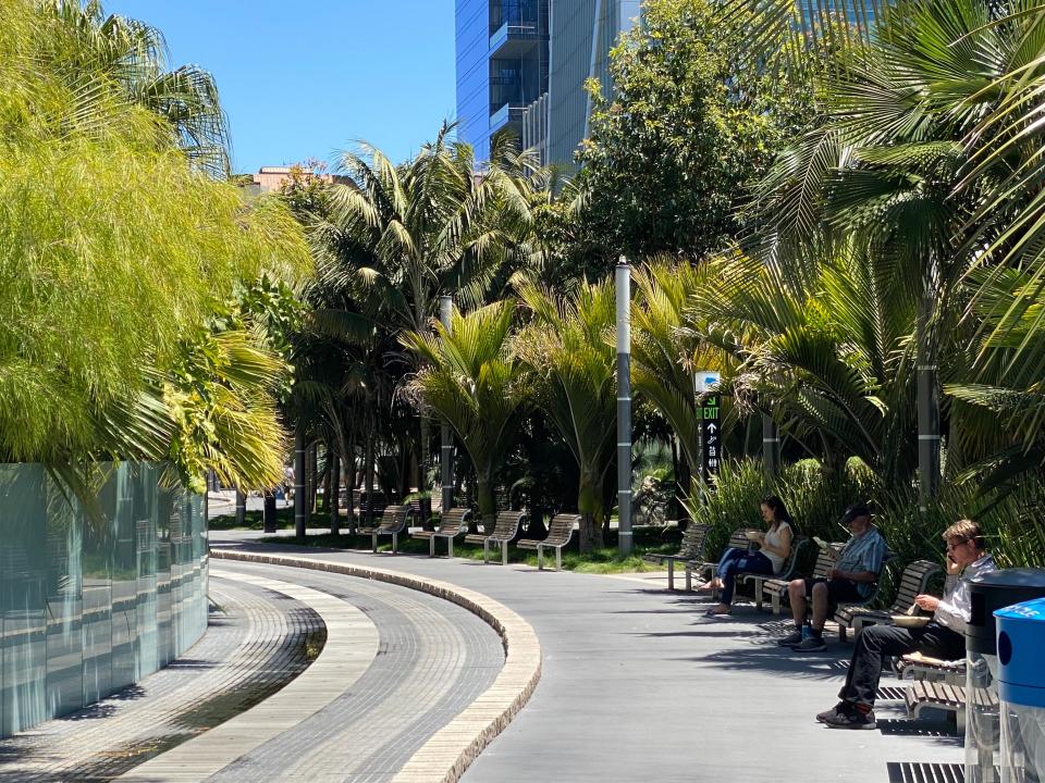 Office workers enjoy a sunny lunch amid tropical plants at Salesforce Park, an elevated green space in San Francisco. (Josh Marcus / The Independent)