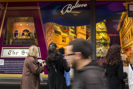 Pedestrians stop to look at holiday window displays at Macy's flagship store in New York, November 22, 2013. REUTERS/Lucas Jackson