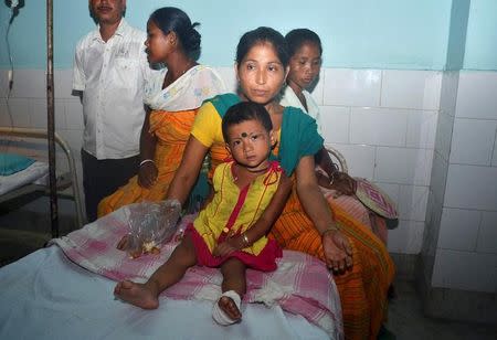 A woman sits next to her daughter, who got injured during an attack by gunmen at a market, at a hospital on the outskirts of Kokrajhar town, in Assam, India August 5, 2016. REUTERS/Stringer