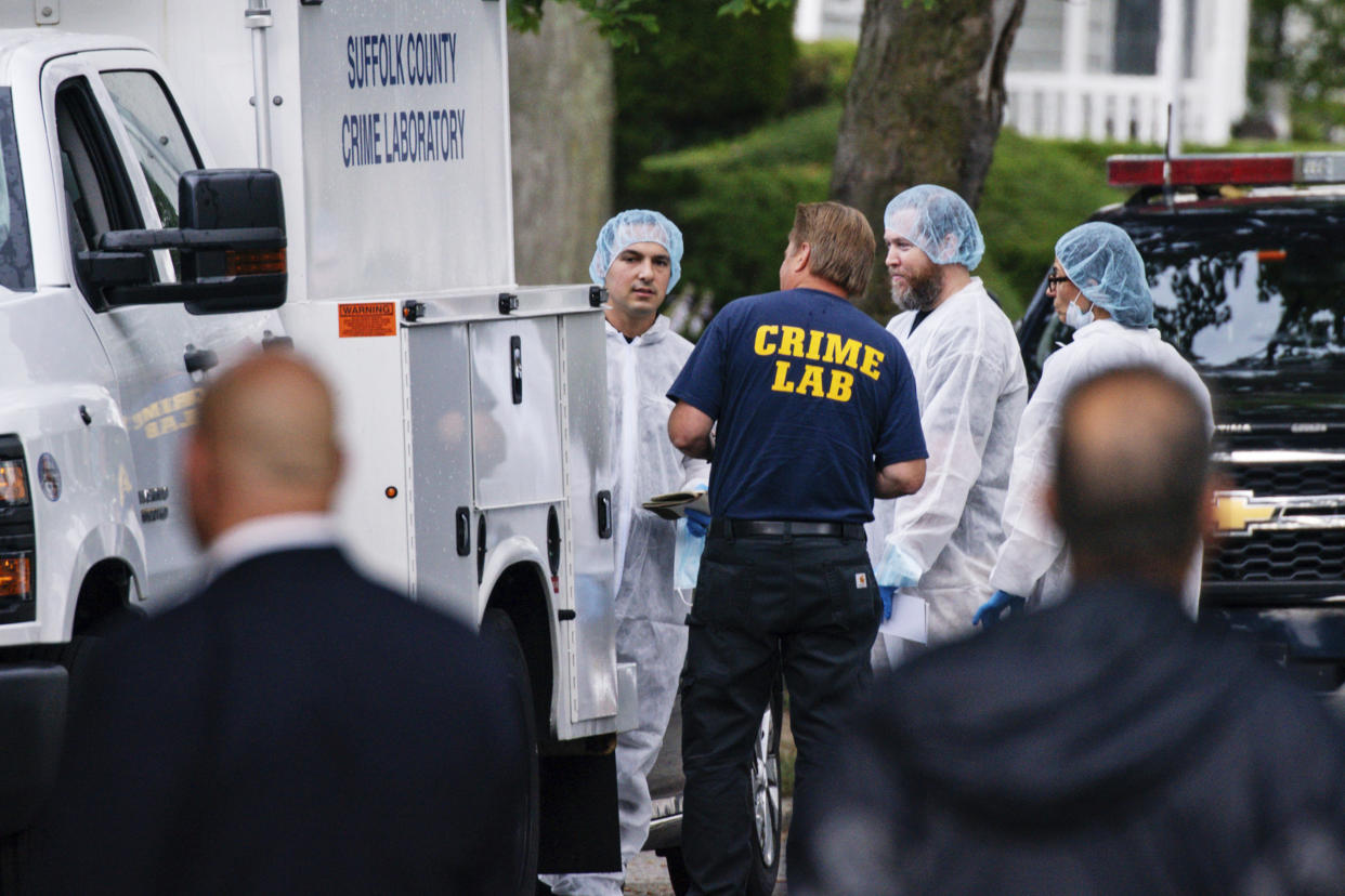 Crime lab officers arrive at the house where a suspect has been taken into custody on New York's Long Island in connection with a long-unsolved string of killings, on Friday, July 14, 2023, in Massapequa. (Eduardo Munoz Alvarez / AP)