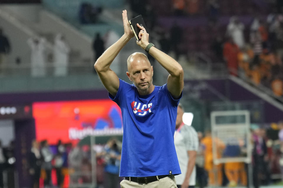 head coach Gregg Berhalter of the United States salutes supporters at the end of the World Cup round of 16 soccer match between the Netherlands and the United States, at the Khalifa International Stadium in Doha, Qatar, Saturday, Dec. 3, 2022. (AP Photo/Francisco Seco)