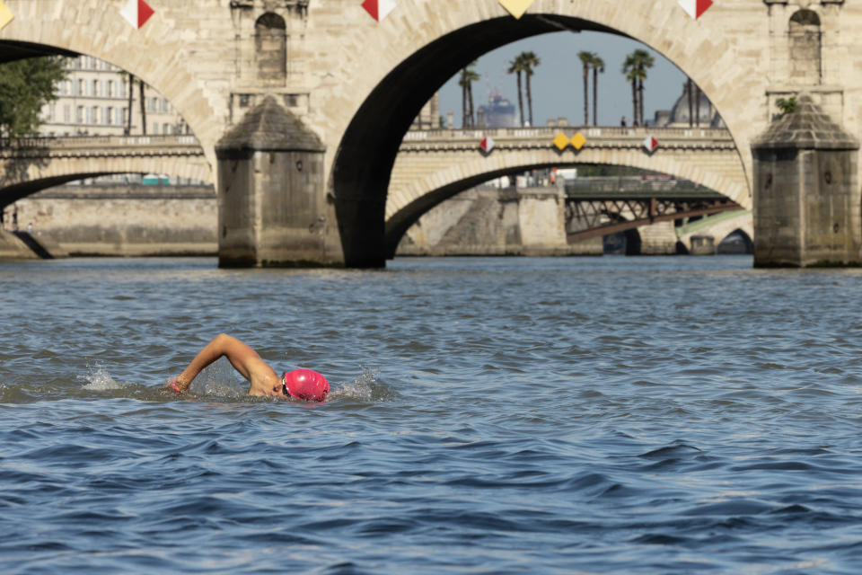 A local resident swims in the Seine, in Paris on July 17, 2024, after the mayor of Paris  swim in the river to demonstrate that it is clean enough to host the outdoor swimming events at the Paris Olympics later this month. Despite an investment of 1.4 billion euros ($1.5 billion) to prevent sewage leaks into the waterway, the Seine has been causing suspense in the run-up to the opening of the Paris Games on July 26 after repeatedly failing water quality tests. But since the beginning of July, with heavy rains finally giving way to sunnier weather, samples have shown the river to be ready for the open-water swimming and triathlon. (Photo by JOEL SAGET / AFP) (Photo by JOEL SAGET/AFP via Getty Images)