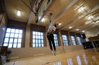 Kenny Scottborough, 19, goes up for a shot in an empty gymnasium at West Brooklyn Community High School, Thursday, Oct. 29, 2020, in New York. The high school is a "transfer school," catering to a students who haven't done well elsewhere, giving them a chance to graduate and succeed. Good Shepherd Services provides advocate counselors to help West Brooklyn's students achieve their goals. (AP Photo/Kathy Willens)