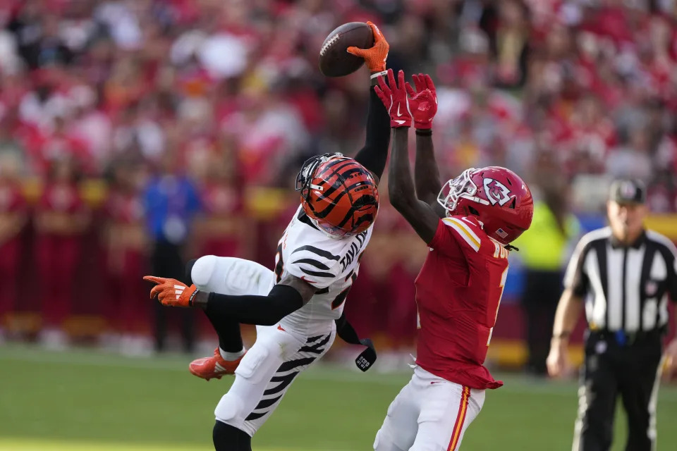 Cincinnati Bengals cornerback Cam Taylor-Britt, left, intercepts a pass intended for Kansas City Chiefs wide receiver Xavier Worthy during the second half of an NFL football game Sunday, Sept. 15, 2024, in Kansas City, Mo. (AP Photo/Charlie Riedel)