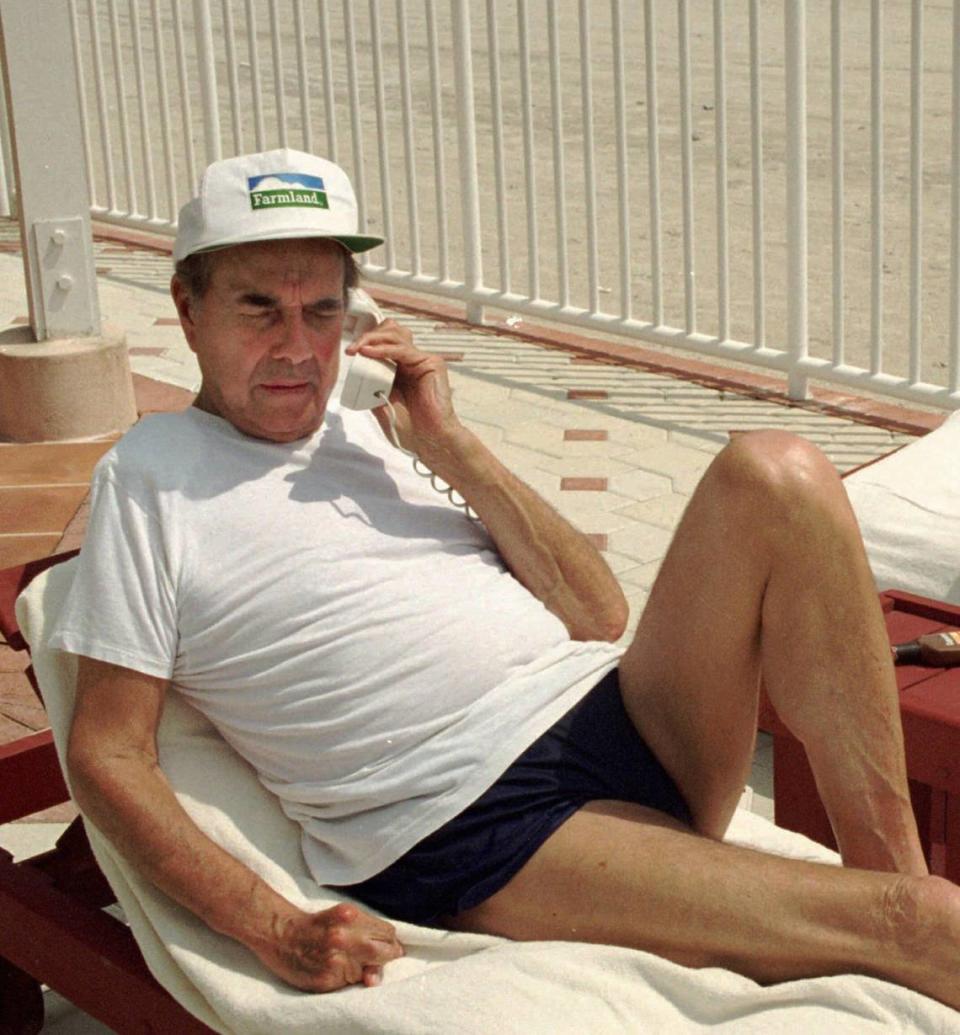 Republican presidential hopeful Sen. Bob Dole, R-Kan., squints in the sun as he fields phone calls and relaxes by the pool at the Sea View Hotel in Bal Harbour.