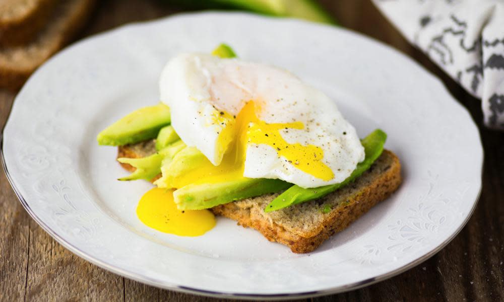Fresh poached egg with avocado on toast.