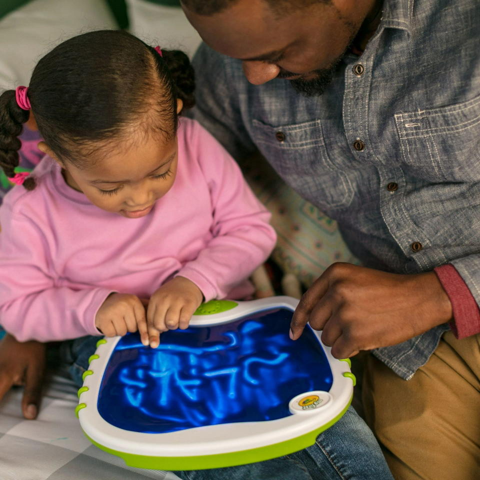 parent watching kid color on doodle pad