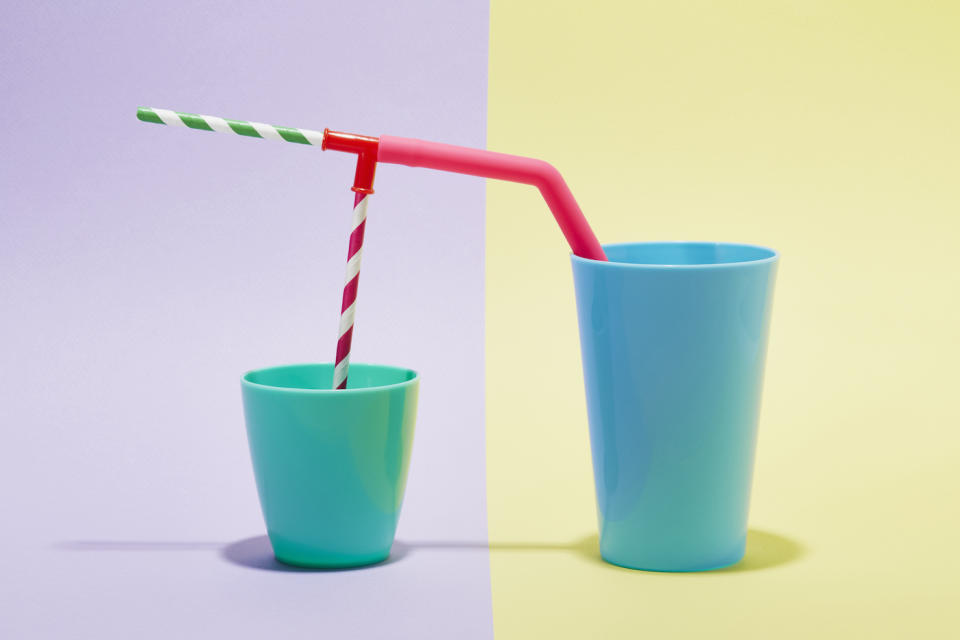 A combination of drinking straws in two cups