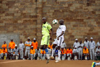 <p>Players jump for the ball during a mock World Cup soccer match between Russia and Saudi Arabia at the Kamiti Maximum Security Prison, near Nairobi, Kenya, on June 14, 2018. (Photo: Baz Ratner/Reuters) </p>