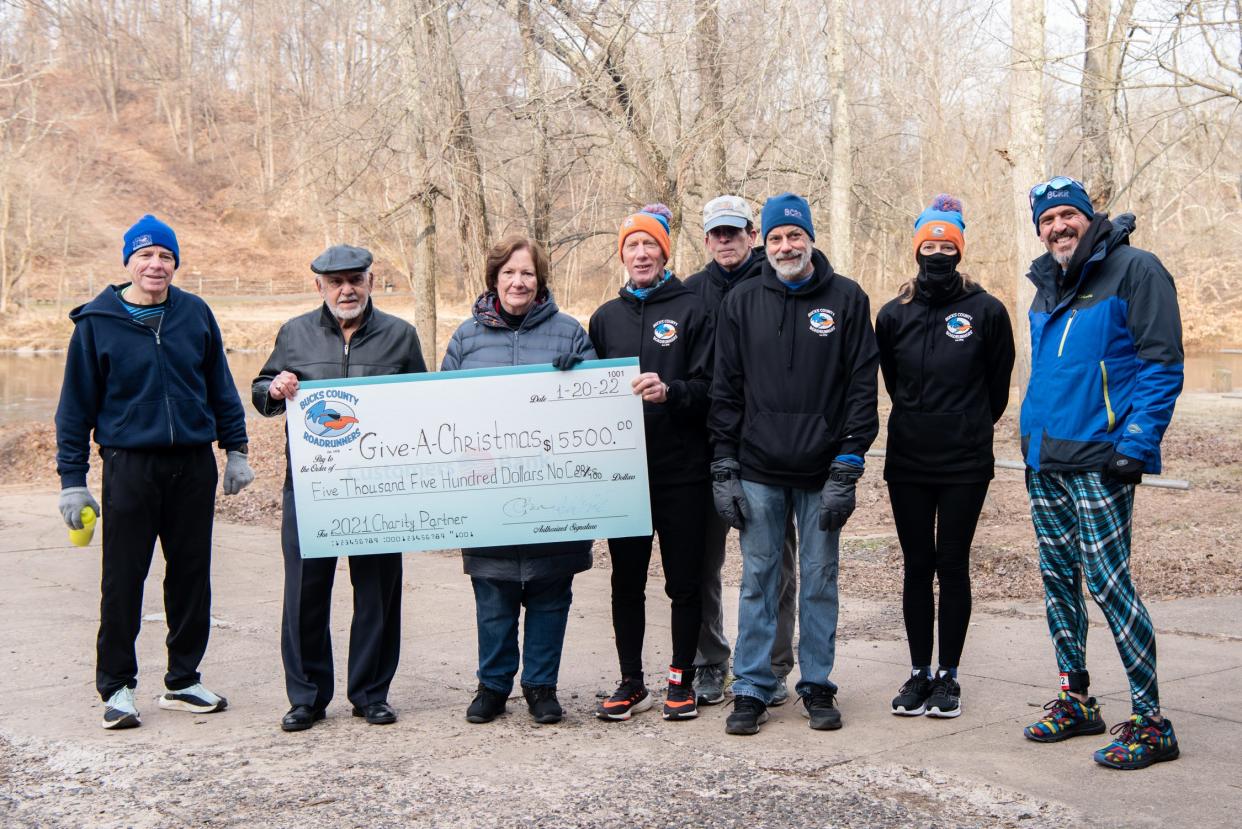 Bill Schaffling, Rich Kanak, Phil Miele, Matt Conard, Kathy McKinney, and John O'Brien, present a $5,500 check from the Bucks County Roadrunners to Joe DeFranco, second from left, and Mary Berman, third from left, of the Levittown-Bristol Kiwanis Club, on Sunday, January 23, 2022, at Tyler State Park in Newtown. The donation will go to the Bucks County Courier Times and Levittown-Bristol Kiwanis Club Give A Christmas fund.