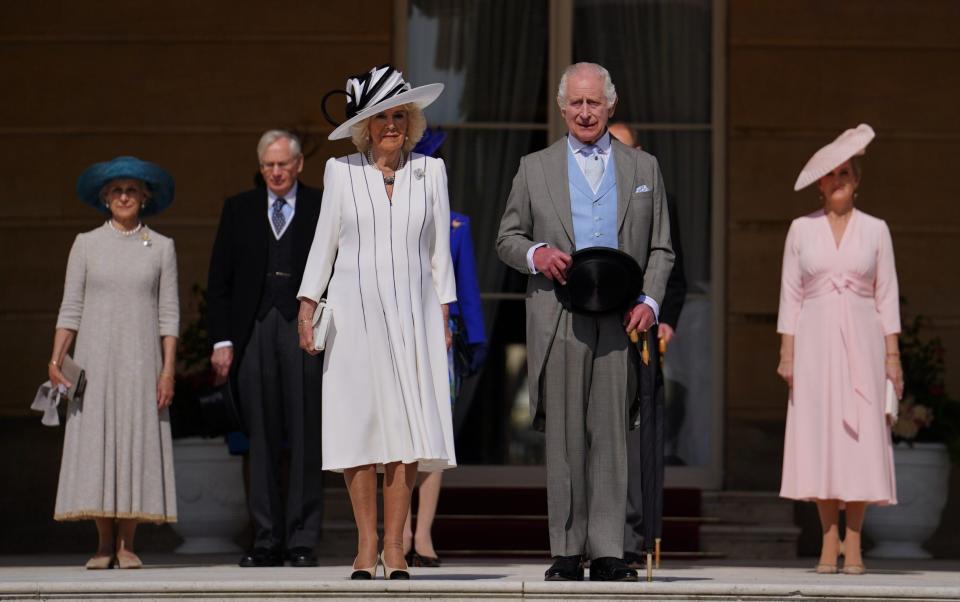 The King hosted a garden party while his son was a few miles up the road