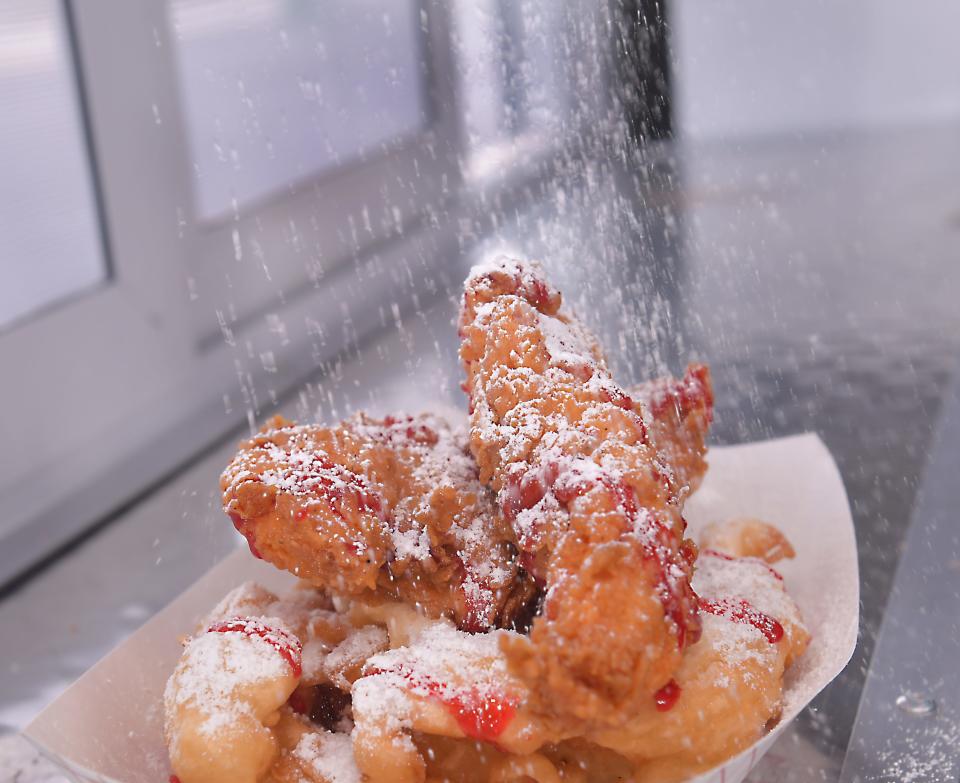 Aspen Street Sweets owners Ryan and Natalie Smith will open a second AJ's Street Kravz food truck in March.  This is an order of Crispy Golden Chicken Funnel Cake with a shower of powdered sugar.  This dish is topped with tender, hand-breaded signature marinade fillets, drizzled with maple strawberries.