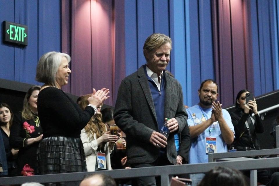 New Mexico Gov. Michelle Lujan Grisham, left, and others clap as actor William H. Macy enters a Cineport 10 theatre to attend a screening of the Academy Award-winning movie "Fargo," during the 2022 Las Cruces International Film Festival on March 3, 2022.